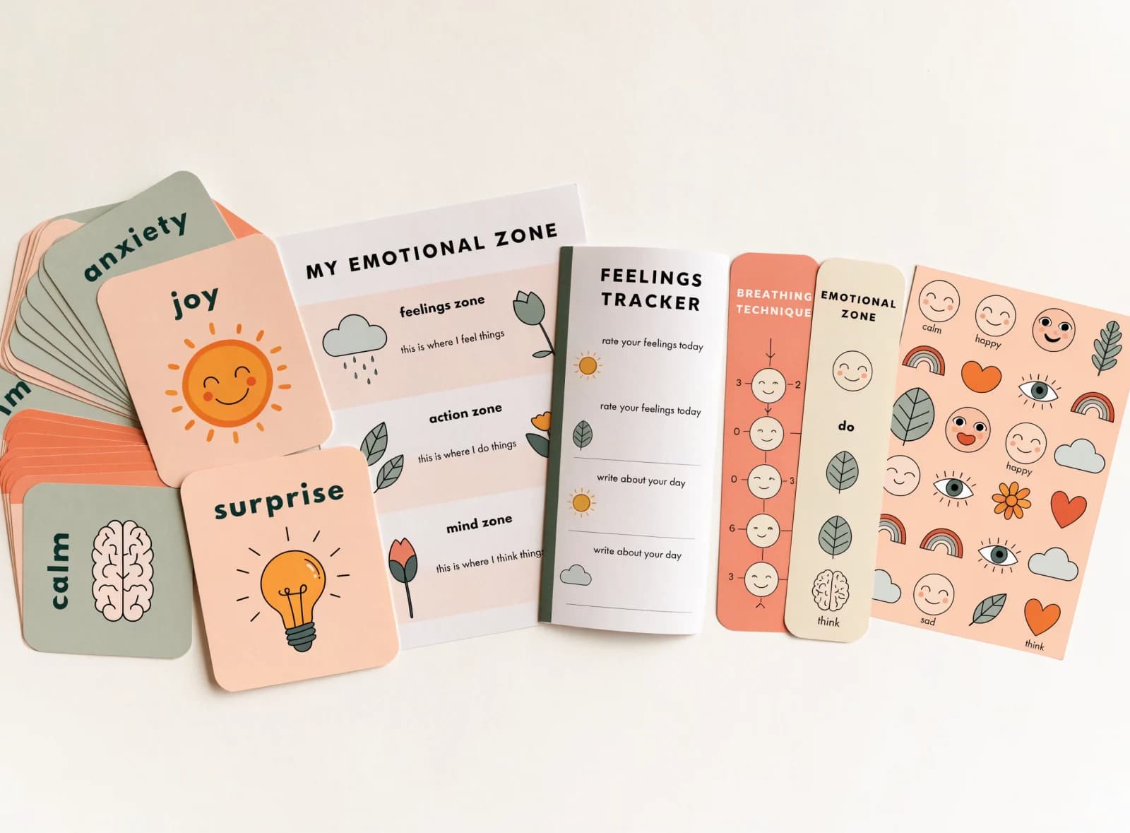 A children's learning collection laid out together: emotion flashcards, a feelings poster, an activity booklet, bookmarks and a sticker sheet